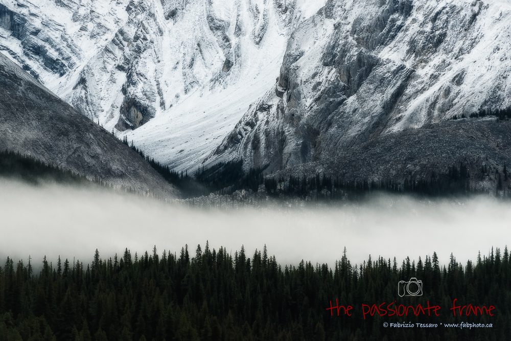 A fresh morning as the low clouds make there way across mountains at Maligne Lake in Jasper National Park, Alberta, Canada.
